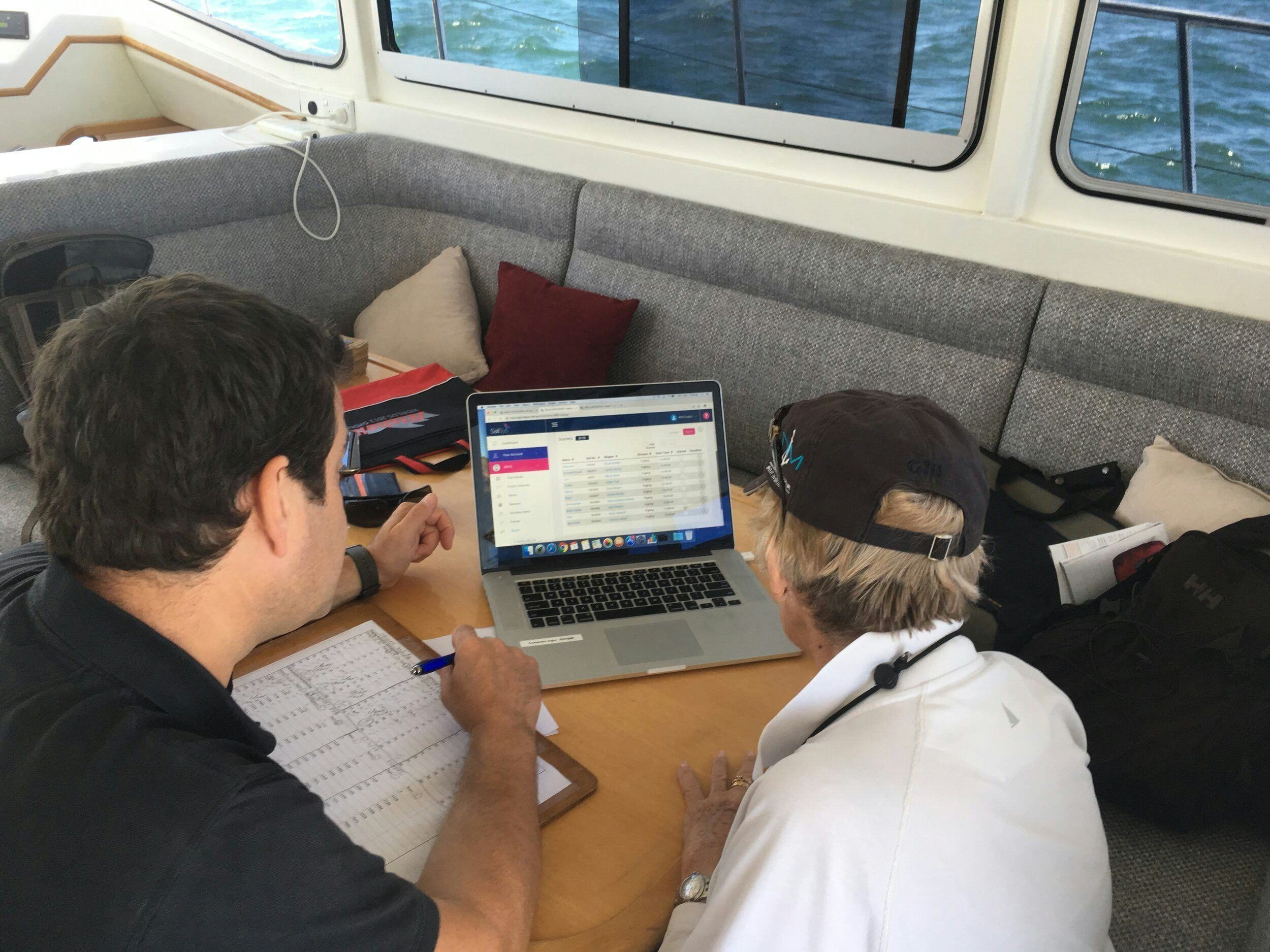 A photo of SailSys being used on a laptop on a committee boat